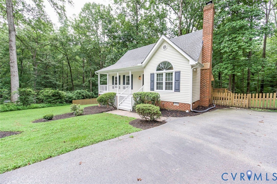 14001 Branched Antler Drive, Antler Ridge, Midlothian, VA 23112 Vinyl siding exterior with a prominent brick chimney, arched window, and covered front porch