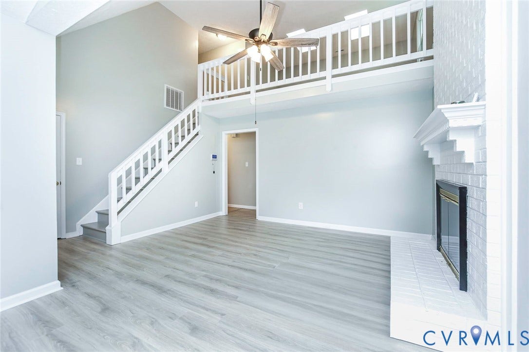 14001 Branched Antler Drive, Antler Ridge, Midlothian, VA 23112 Vaulted ceiling with an overhead fan, wood-finish flooring, white brick fireplace with a mantel, and a loft with a white railing