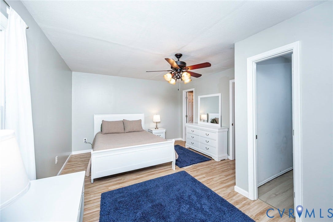 14001 Branched Antler Drive, Antler Ridge, Midlothian, VA 23112 Spacious room featuring wood-finish flooring, a ceiling fan with integrated lighting, and neutral wall tones