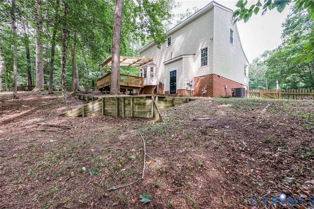 14001 Branched Antler Drive, Antler Ridge, Midlothian, VA 23112 Multi-level wood deck with a partial covering, bay window, and a brick foundation