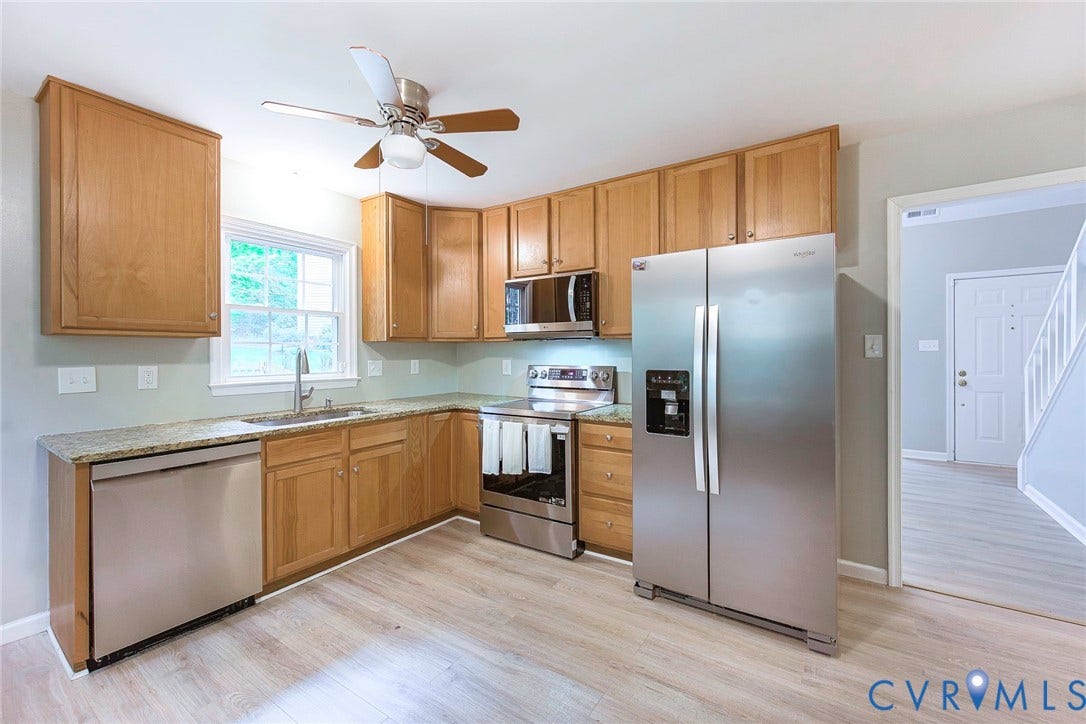 14001 Branched Antler Drive, Antler Ridge, Midlothian, VA 23112 Wood-finish flooring, stainless steel appliances, light wood cabinetry, granite-style countertops, and a ceiling fan with integrated lighting