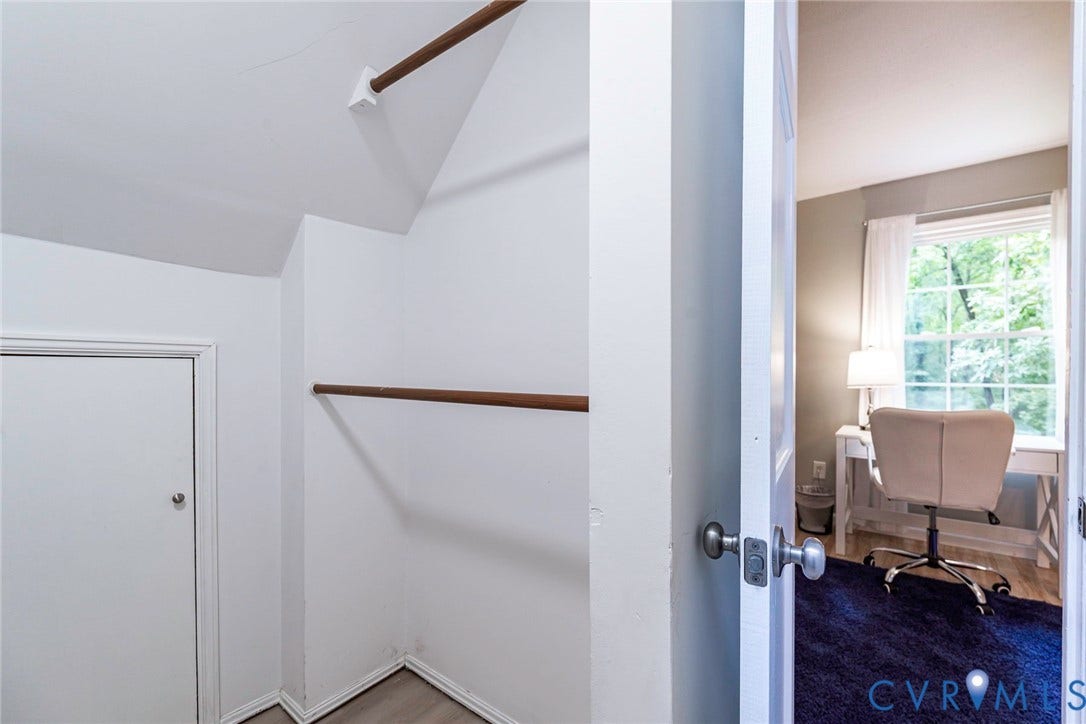 14001 Branched Antler Drive, Antler Ridge, Midlothian, VA 23112 Walk-in closet with sloped ceiling, wood-finish hanging rods, and a white interior door