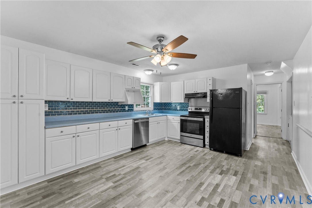 12870 King William Road, King William, VA 23086 Kitchen featuring white cabinetry, blue countertops, tile backsplash, stainless steel appliances, and wood-finish flooring