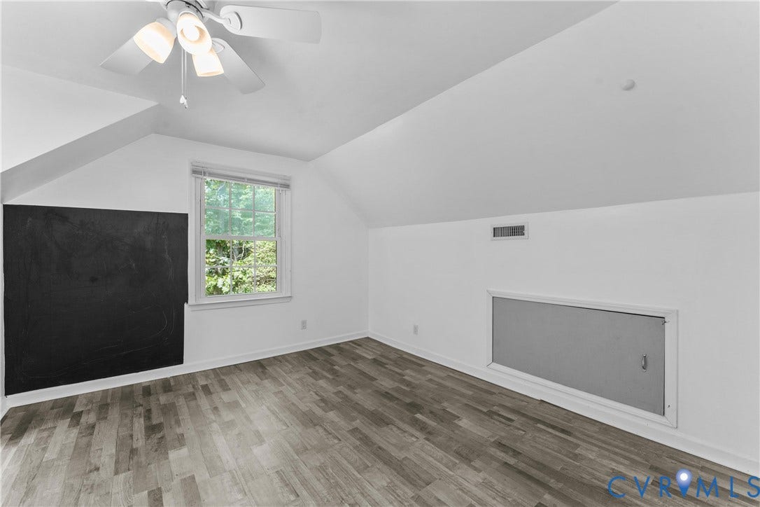 12870 King William Road, King William, VA 23086 Sloped ceiling room featuring wood-finish flooring, a window with natural light, and a ceiling fan with integrated lighting