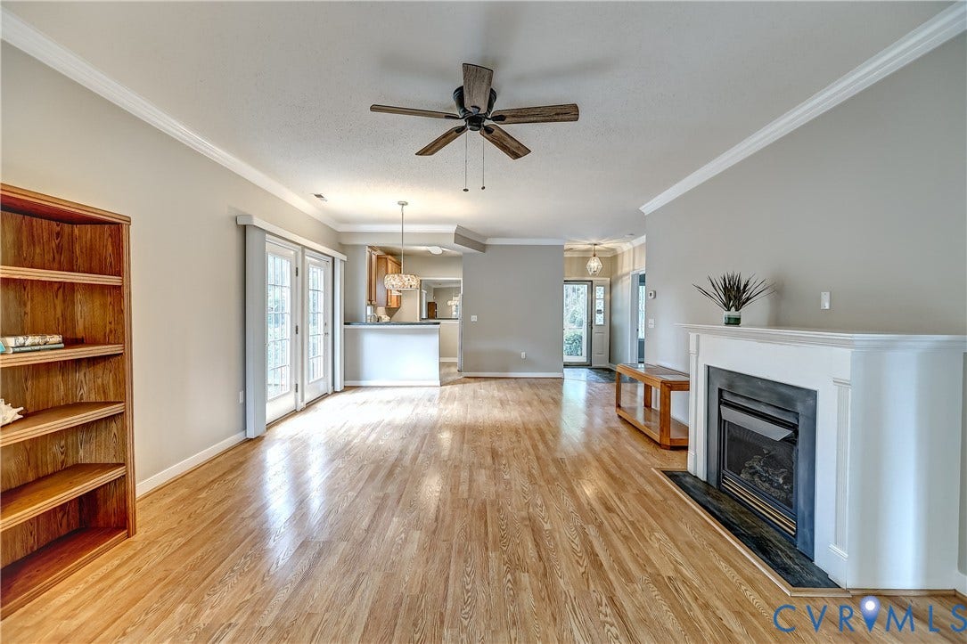 4602 Twin Hickory Lake Drive, Twin Hickory, Glen Allen, VA 23059 Living area featuring wood-finish flooring, a white mantel fireplace with a dark hearth, and crown molding
