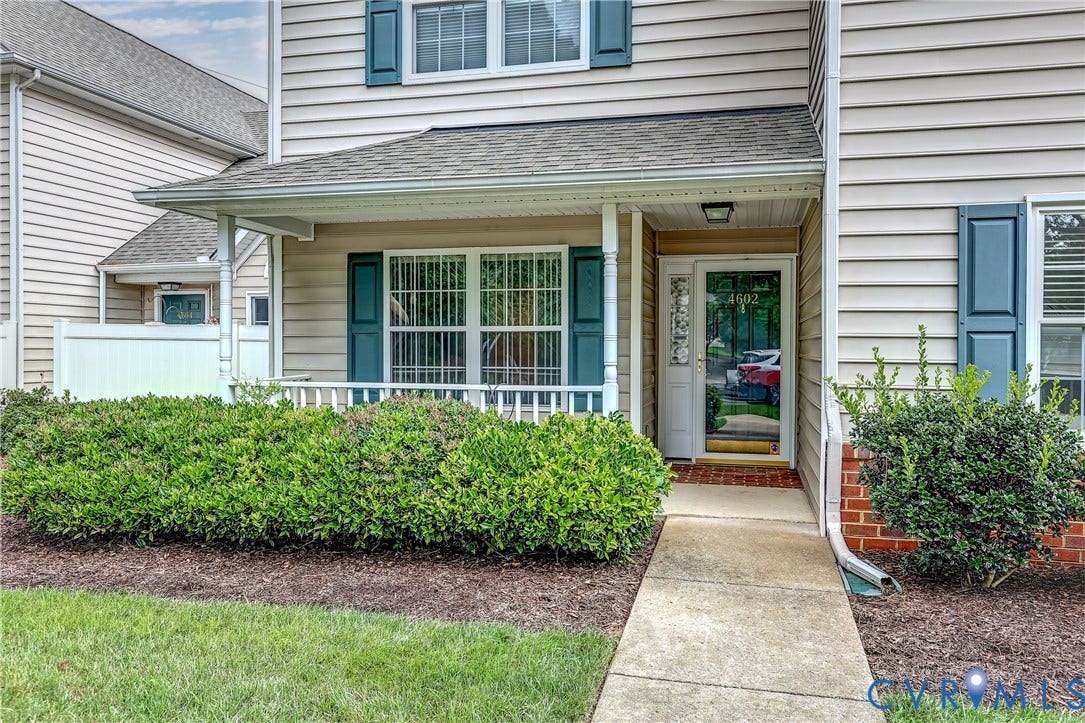 4602 Twin Hickory Lake Drive, Twin Hickory, Glen Allen, VA 23059 Welcoming front entrance featuring a covered porch with white railings, paneled entry door with sidelights, and manicured landscaping with established shrub beds flanking the walkway