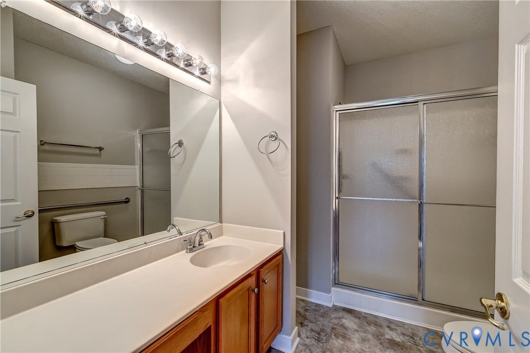 4602 Twin Hickory Lake Drive, Twin Hickory, Glen Allen, VA 23059 Spacious primary bathroom featuring a wood-finish vanity with dual-sink configuration, white quartz countertop, and large illuminated mirror