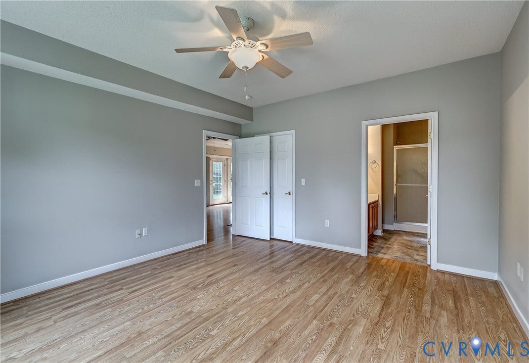 4602 Twin Hickory Lake Drive, Twin Hickory, Glen Allen, VA 23059 Spacious bedroom featuring wood-finish flooring, neutral gray walls, and a ceiling fan with integrated lighting