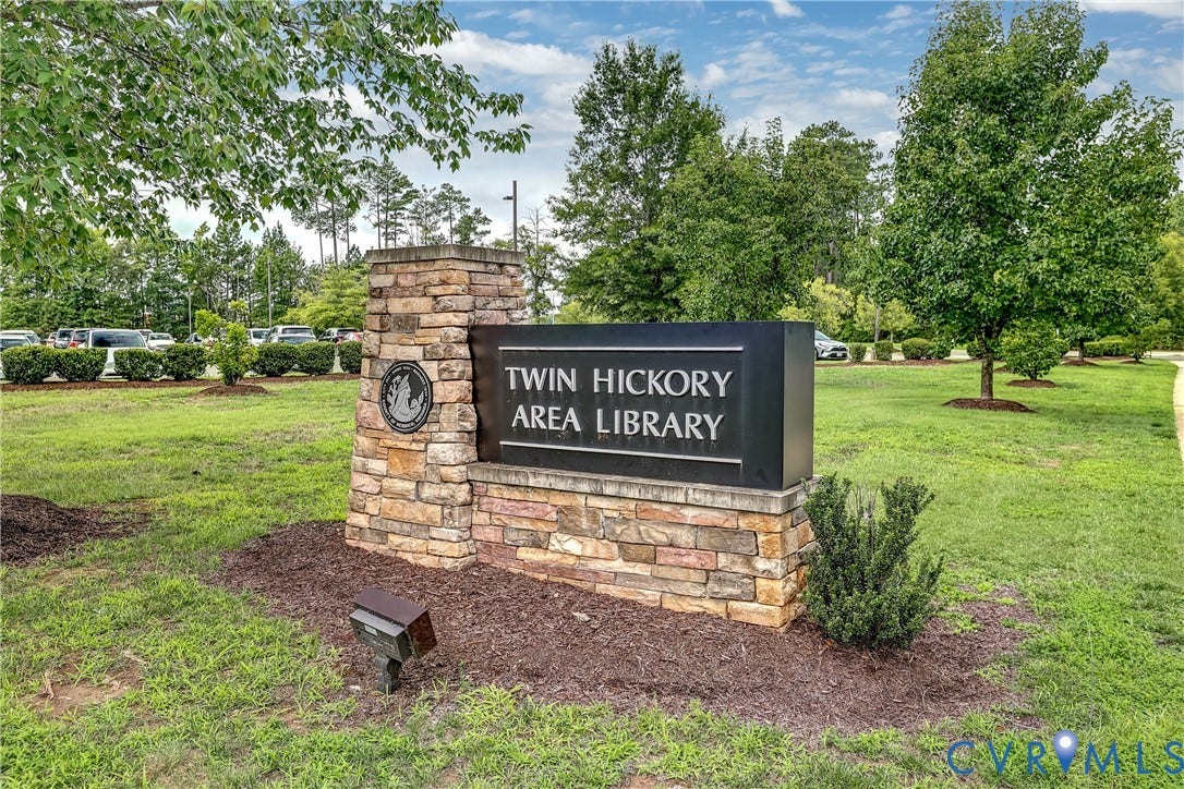 4602 Twin Hickory Lake Drive, Twin Hickory, Glen Allen, VA 23059 Twin Hickory Area Library grounds feature a manicured lawn with mature shade trees, stone monument signage with black panel detailing, and landscaped perimeter plantings set within a spacious park setting