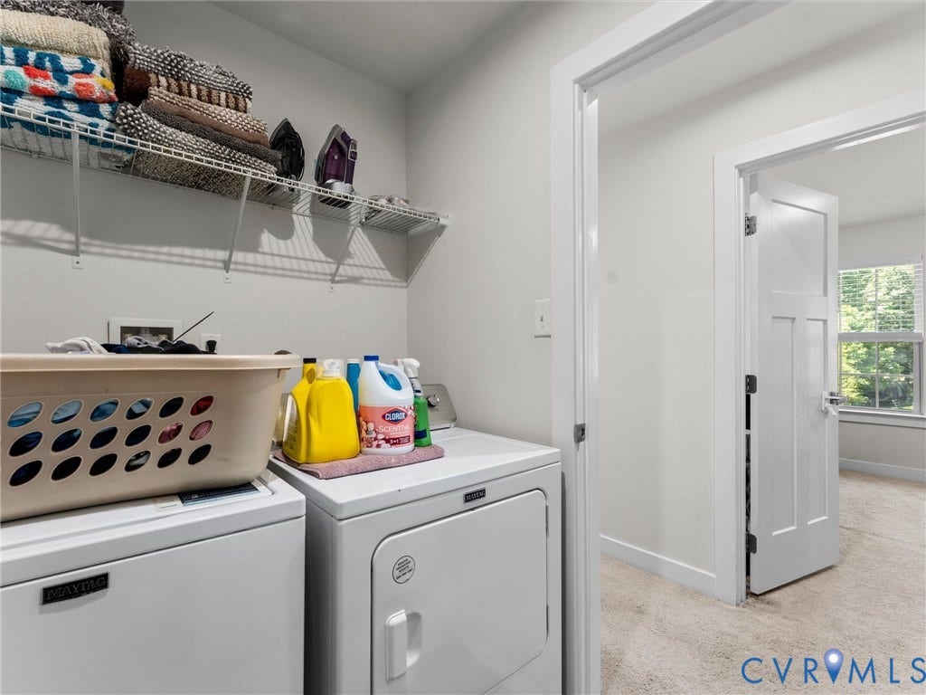 10419 Centralia Station Road, Chester, VA 23831 Dedicated laundry area featuring a washer and dryer, wire shelving, and a nearby room with a window