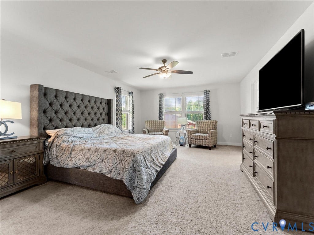 10419 Centralia Station Road, Chester, VA 23831 Spacious room featuring light neutral wall paint, light-colored carpeting, and multiple windows providing natural illumination