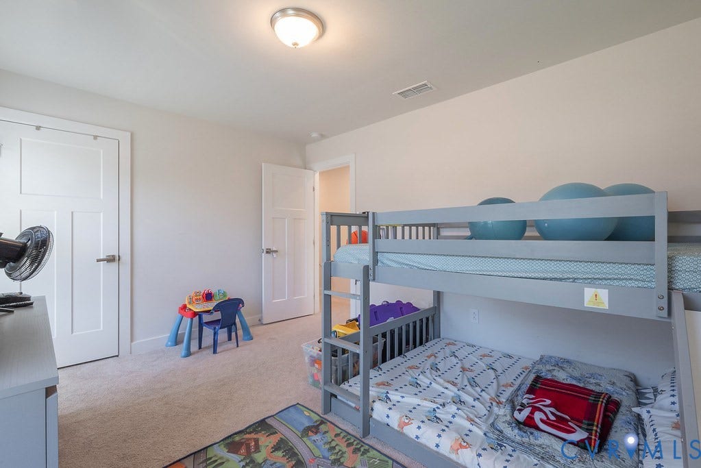 10419 Centralia Station Road, Chester, VA 23831 Spacious room featuring neutral carpeting, light-toned walls, and a ceiling-mounted light fixture