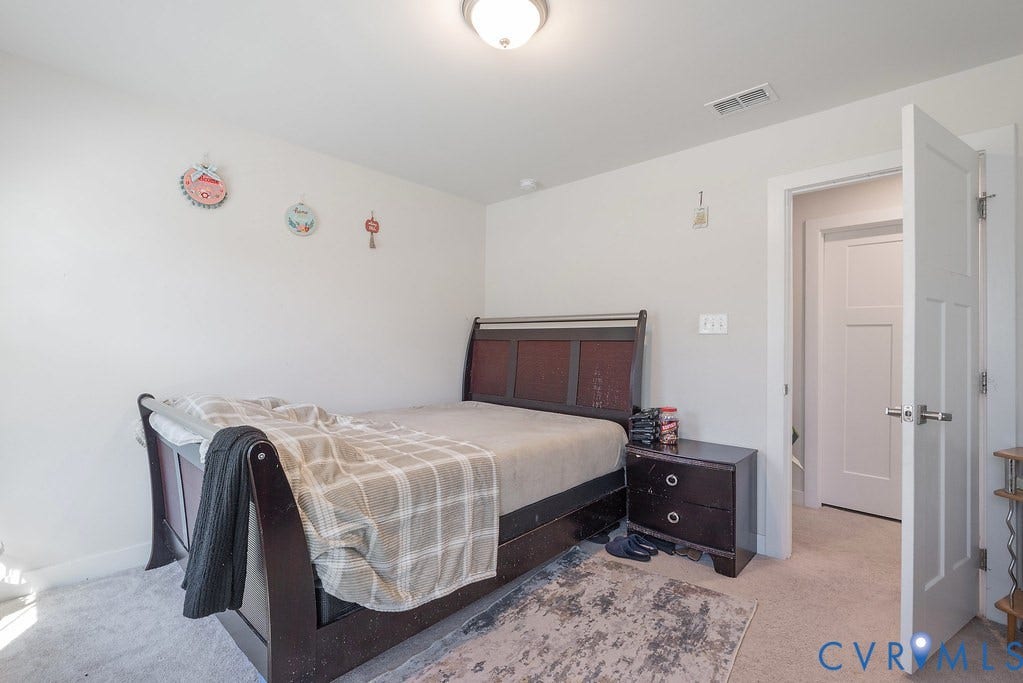 10419 Centralia Station Road, Chester, VA 23831 Carpeted room with white walls, a flush-mount ceiling light fixture, and a white interior door