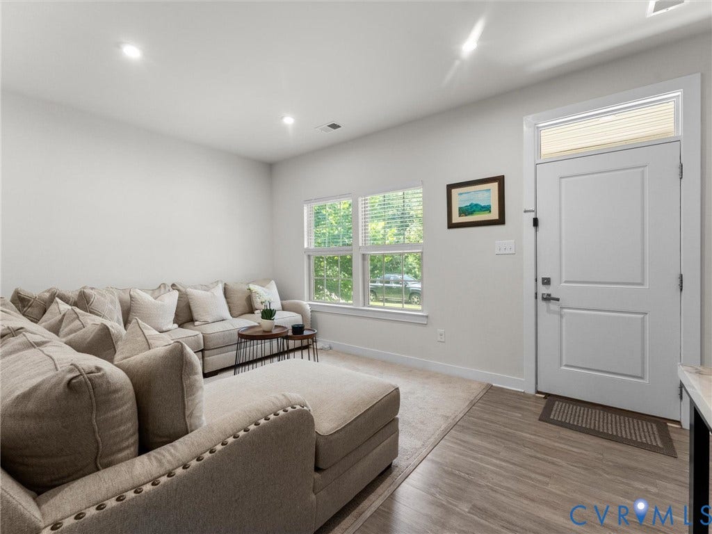 10419 Centralia Station Road, Chester, VA 23831 Open living area featuring wood-finish flooring, recessed lighting, and a white paneled entry door with an overhead transom window