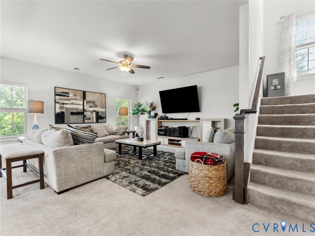 10419 Centralia Station Road, Chester, VA 23831 Spacious living area featuring light-toned carpeting and multiple windows for abundant natural light