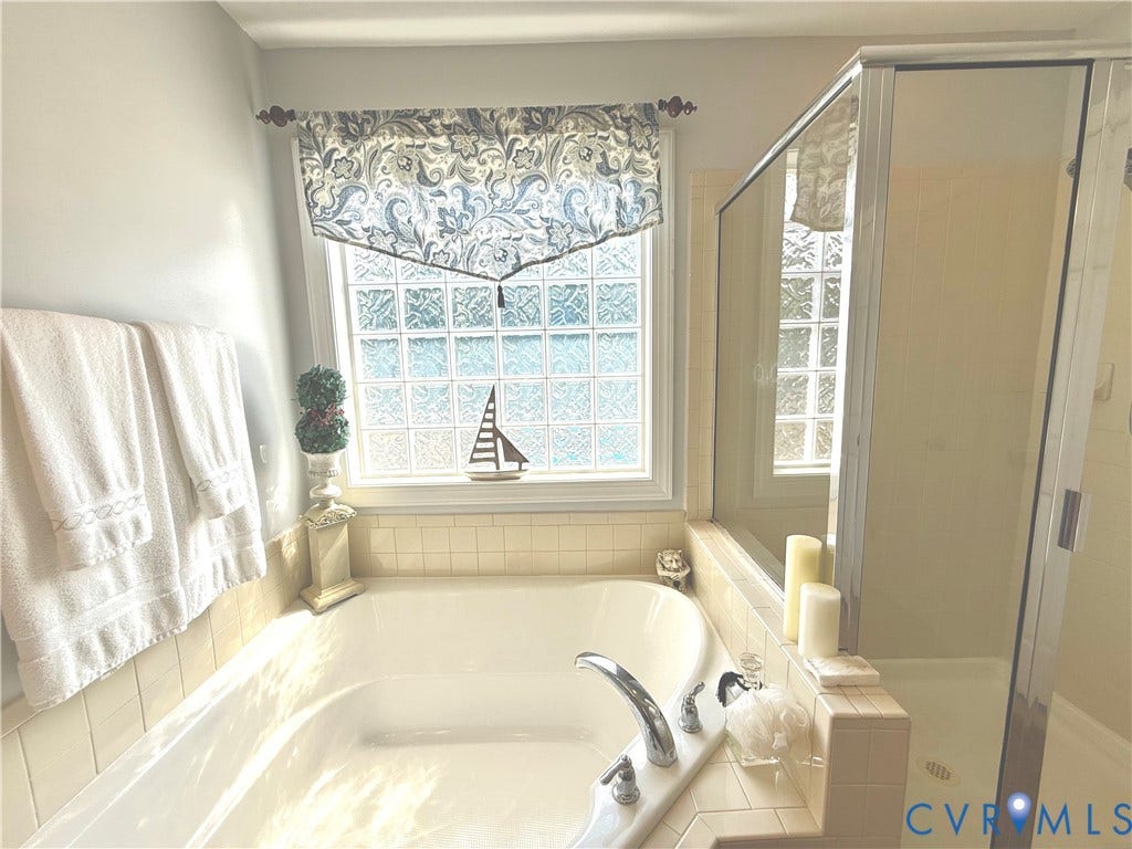 3267 Bayberry Lane, Goochland, VA 23063 Soaking tub with tile surround, paired with a glass-enclosed shower
