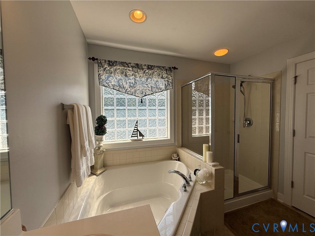 3267 Bayberry Lane, Goochland, VA 23063 Soaking tub with tile surround, glass block window, and adjacent glass-enclosed shower