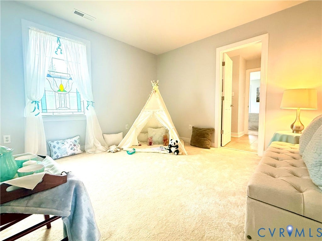 3267 Bayberry Lane, Goochland, VA 23063 Spacious room featuring light-toned carpeting and a window with a decorative stained-glass accent