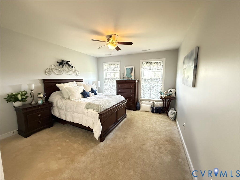 3267 Bayberry Lane, Goochland, VA 23063 Carpeted room featuring a ceiling fan with integrated lighting, two windows with white trim, and light-colored walls