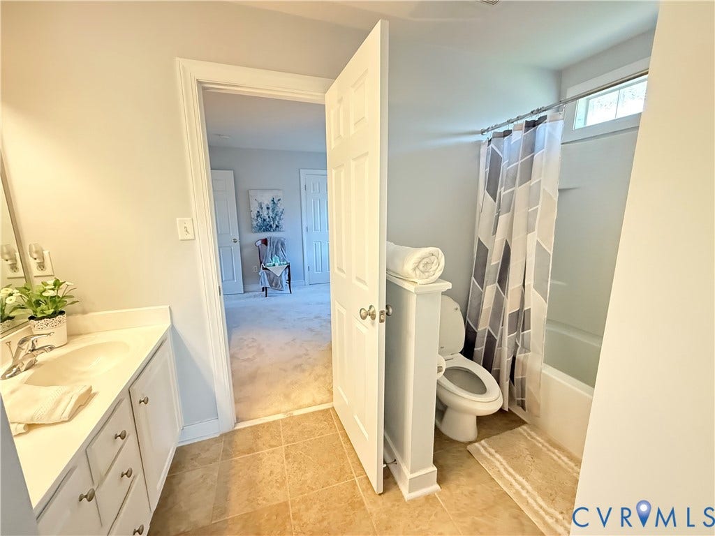 3267 Bayberry Lane, Goochland, VA 23063 Bathroom featuring a single vanity with an undermount sink, a white countertop, and white cabinetry