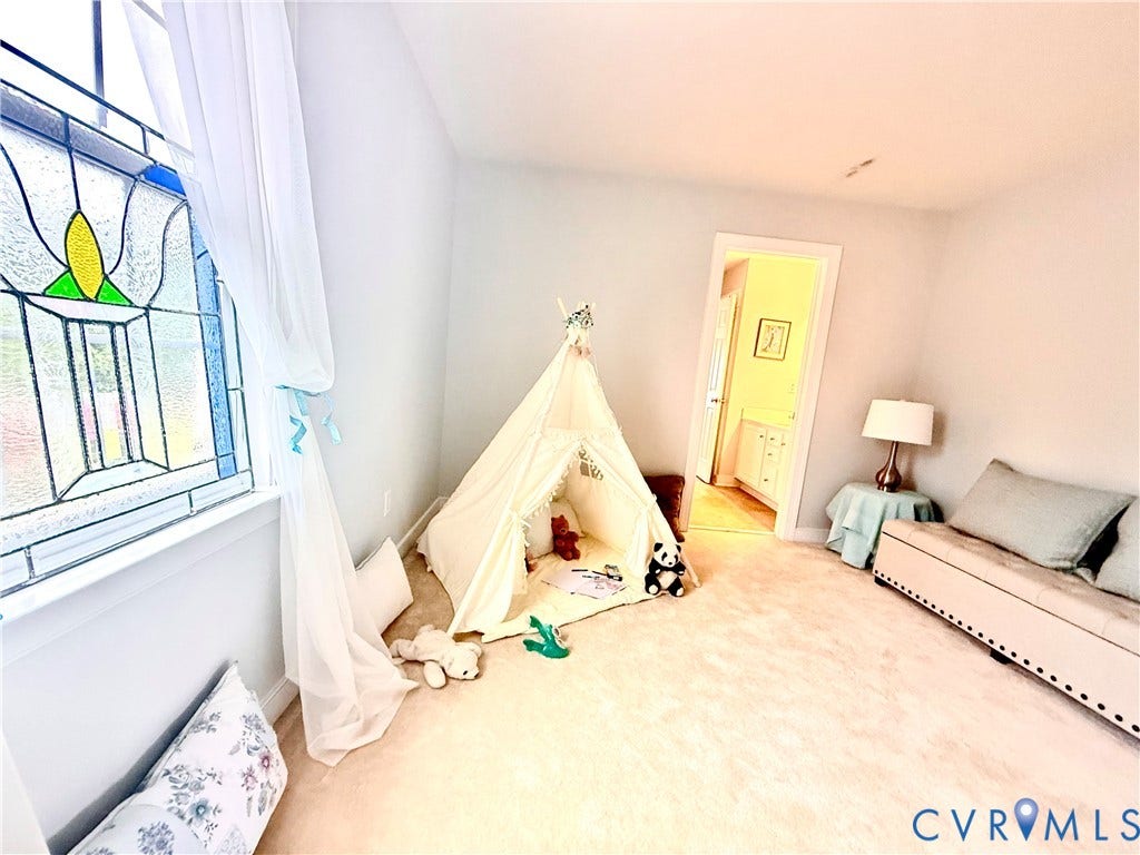 3267 Bayberry Lane, Goochland, VA 23063 Room featuring light-colored carpet flooring, a window with stained glass detailing, and light gray wall paint