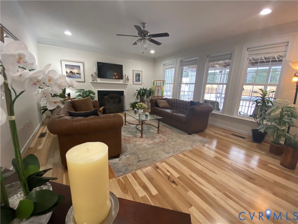 3267 Bayberry Lane, Goochland, VA 23063 Spacious living area featuring light wood-finish flooring, a traditional fireplace with a white mantel, recessed lighting, and a ceiling fan