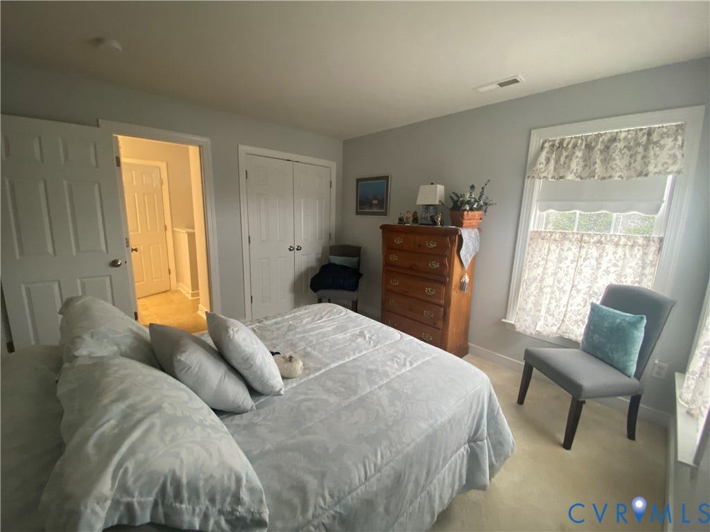 3267 Bayberry Lane, Goochland, VA 23063 Bedroom featuring light gray walls, plush carpet flooring, a window with decorative valances, and a double-door closet
