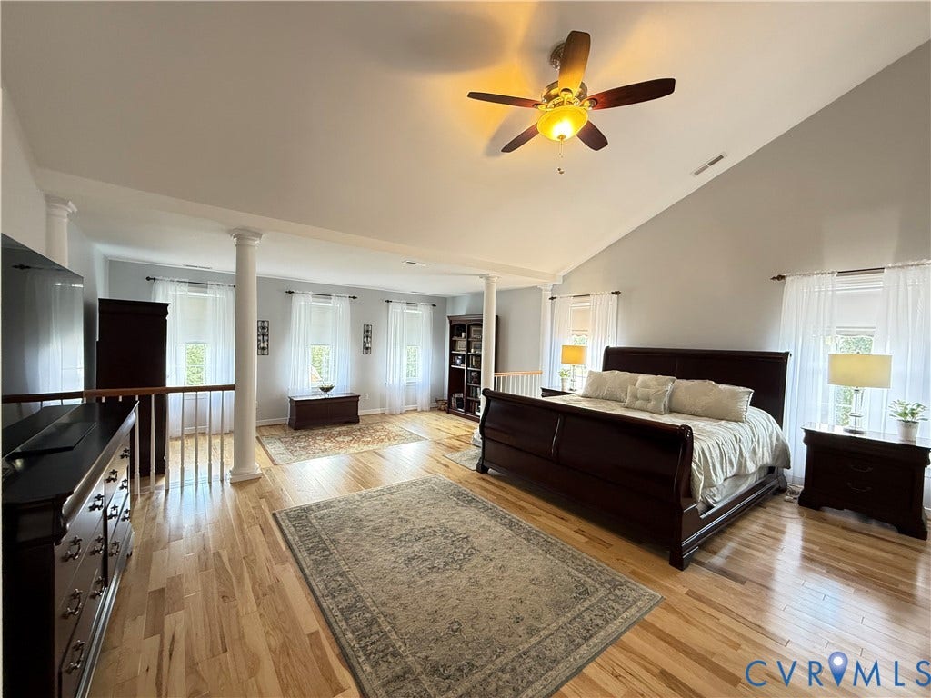 3267 Bayberry Lane, Goochland, VA 23063 Spacious room featuring vaulted ceilings, light wood-finish flooring, and multiple windows