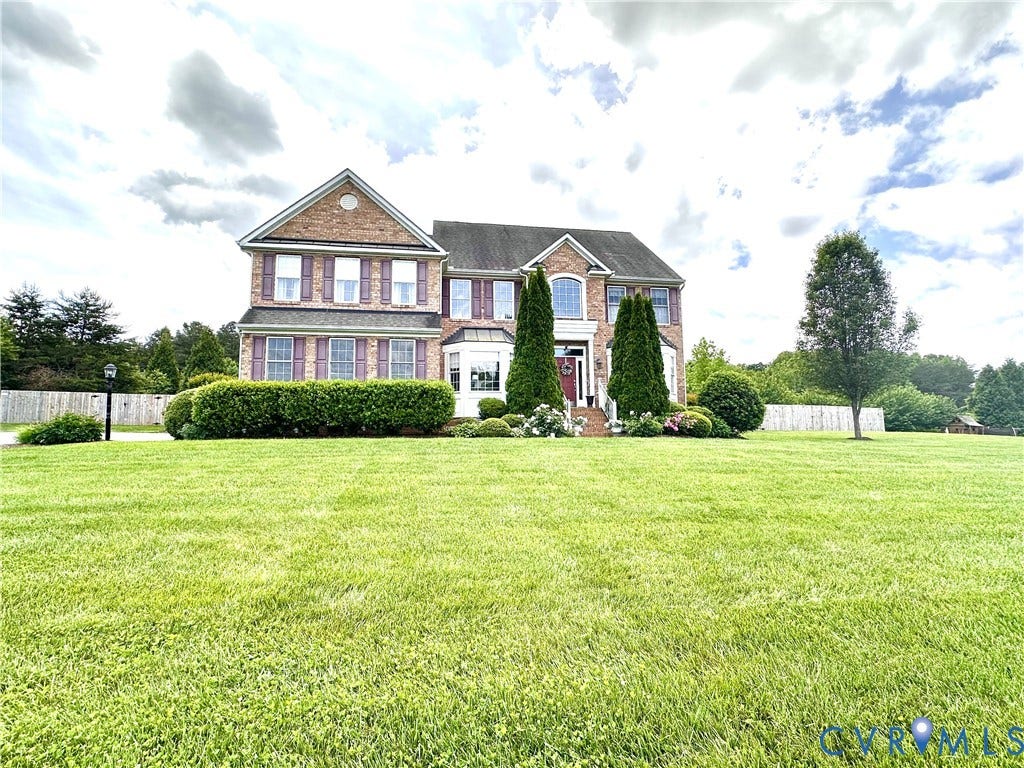 3267 Bayberry Lane, Goochland, VA 23063 Brick facade residence featuring a prominent bay window, decorative shutters, and a covered entry