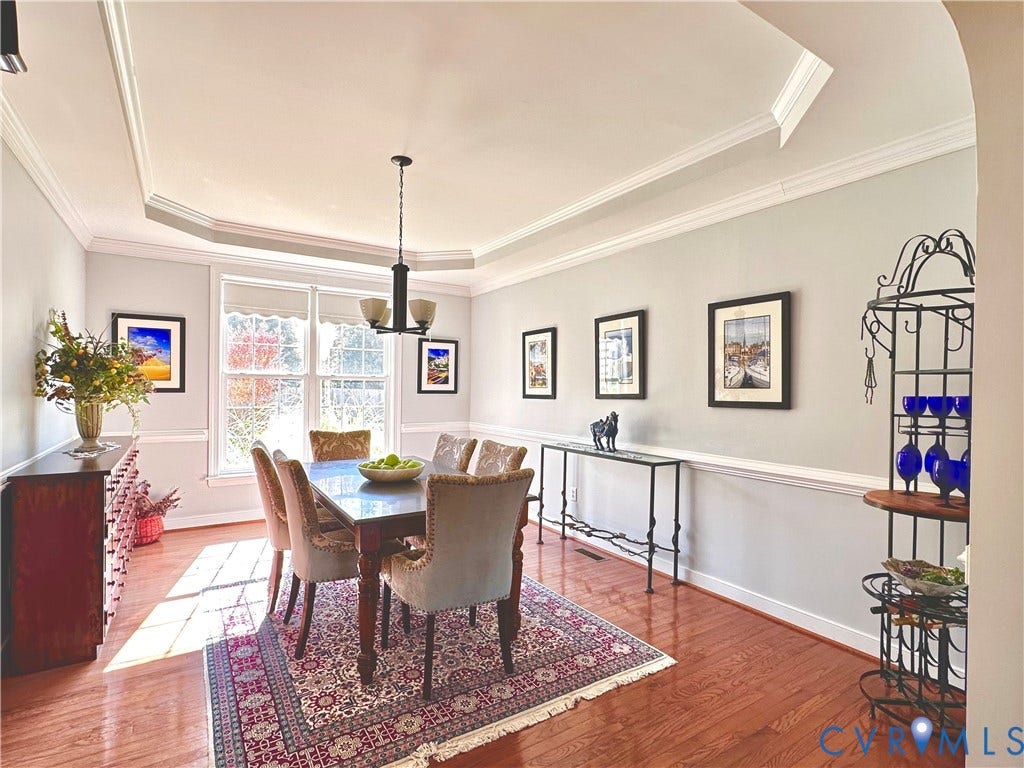 3267 Bayberry Lane, Goochland, VA 23063 Formal dining space featuring wood-finish flooring, tray ceiling with crown molding, and wainscoting