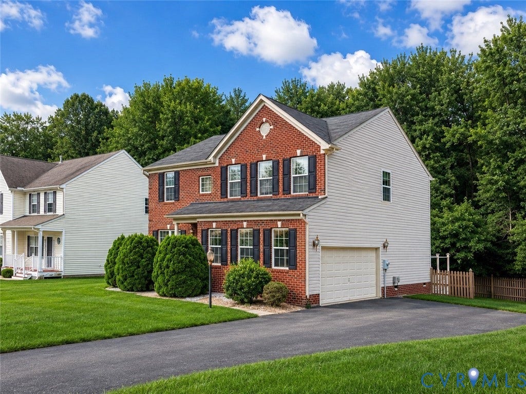 2312 Thomas Kenney Drive, Glen Allen, VA 23060 Traditional two-story residence featuring a brick facade, white siding, and a two-car garage