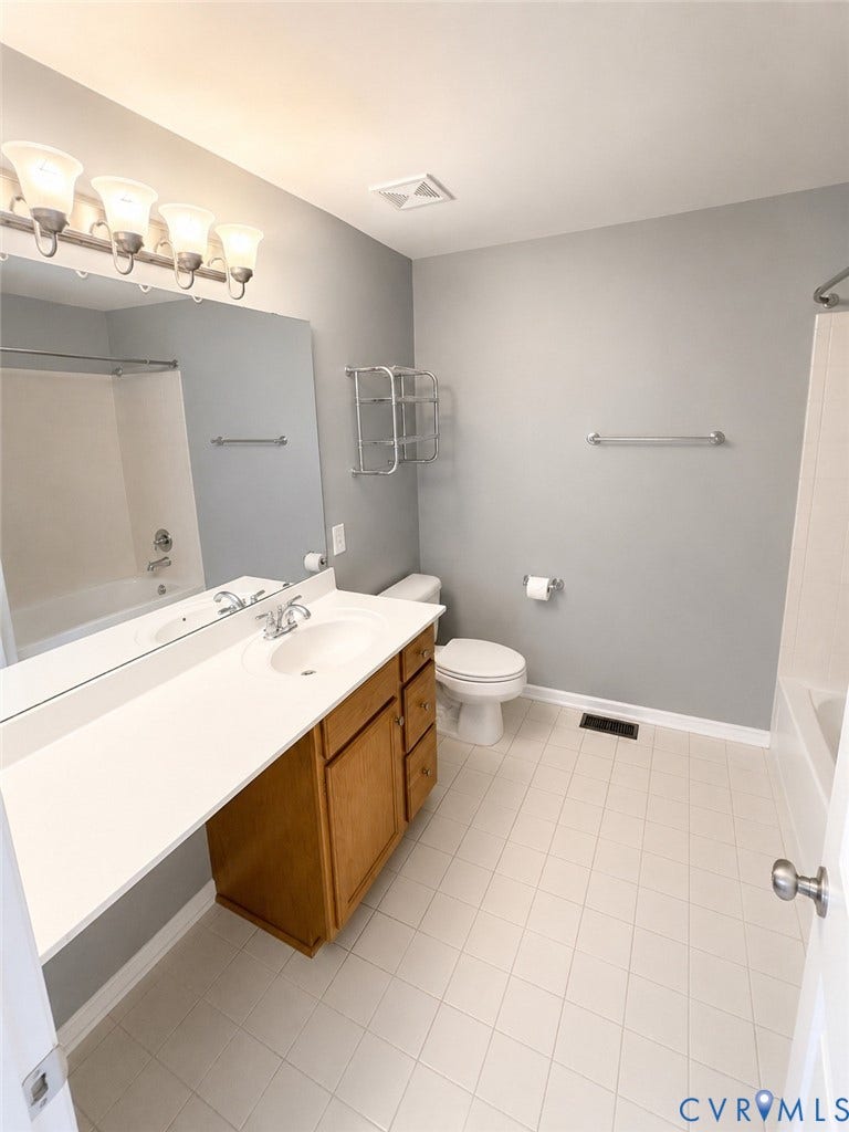 2312 Thomas Kenney Drive, Glen Allen, VA 23060 Bathroom featuring a light wood-finish vanity with an integrated sink, a full-width mirror, tile flooring, and a shower-tub combination