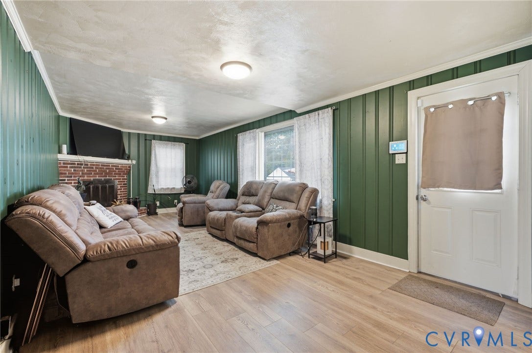 4021 Beulah Road, Chesterfield, VA 23237 Living area featuring wood-finish flooring, green vertical paneling, and white trim