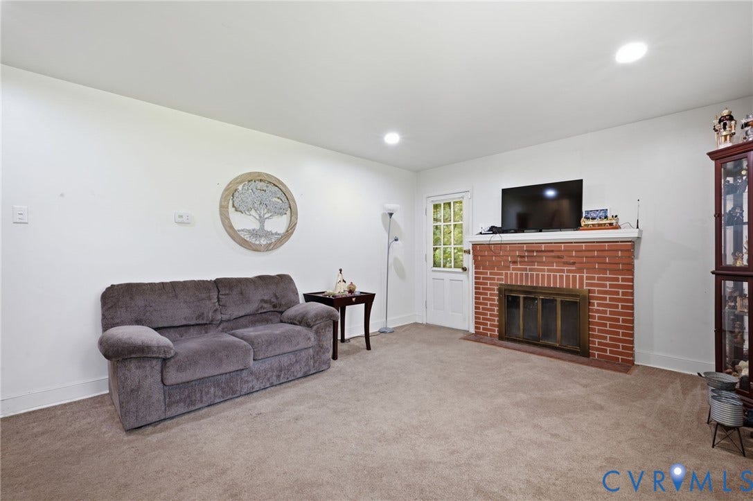 4021 Beulah Road, Chesterfield, VA 23237 Living space featuring a brick fireplace with a hearth, white walls, and recessed lighting