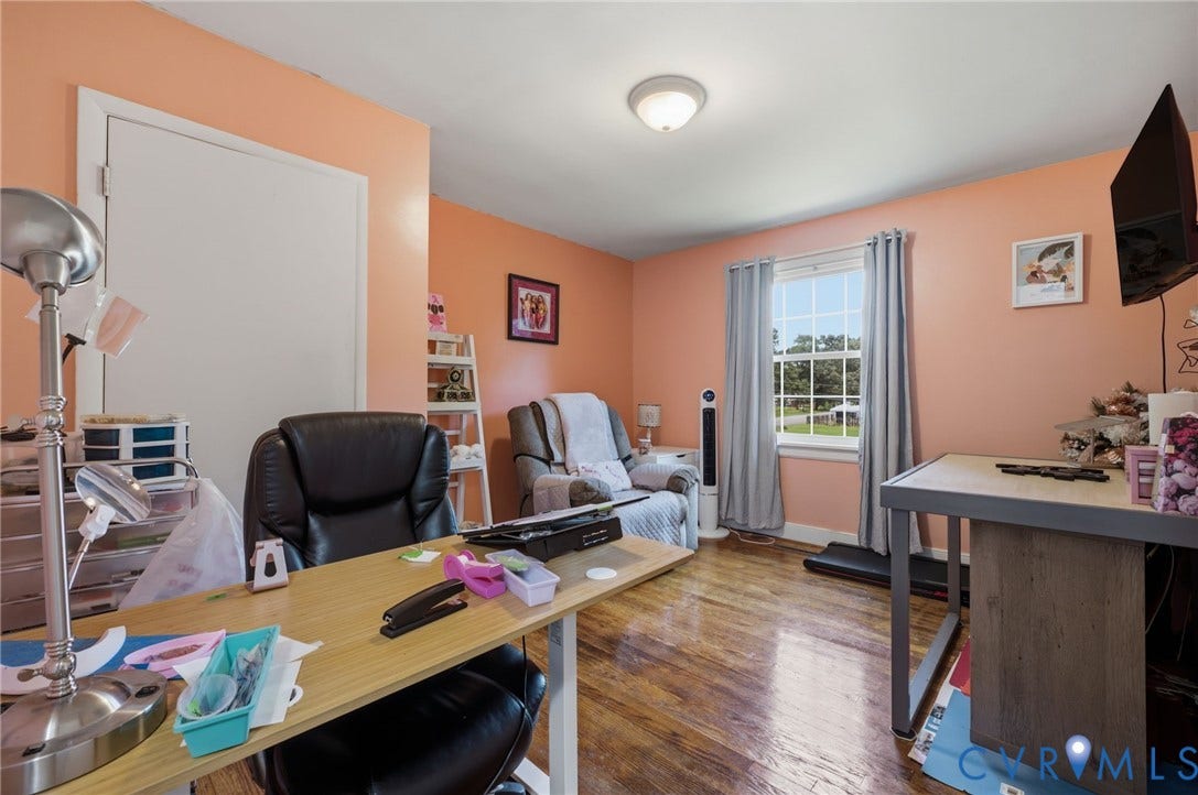4021 Beulah Road, Chesterfield, VA 23237 Spacious room featuring wood-finish flooring, a double-hung window with drapes, and a flush-mount ceiling light