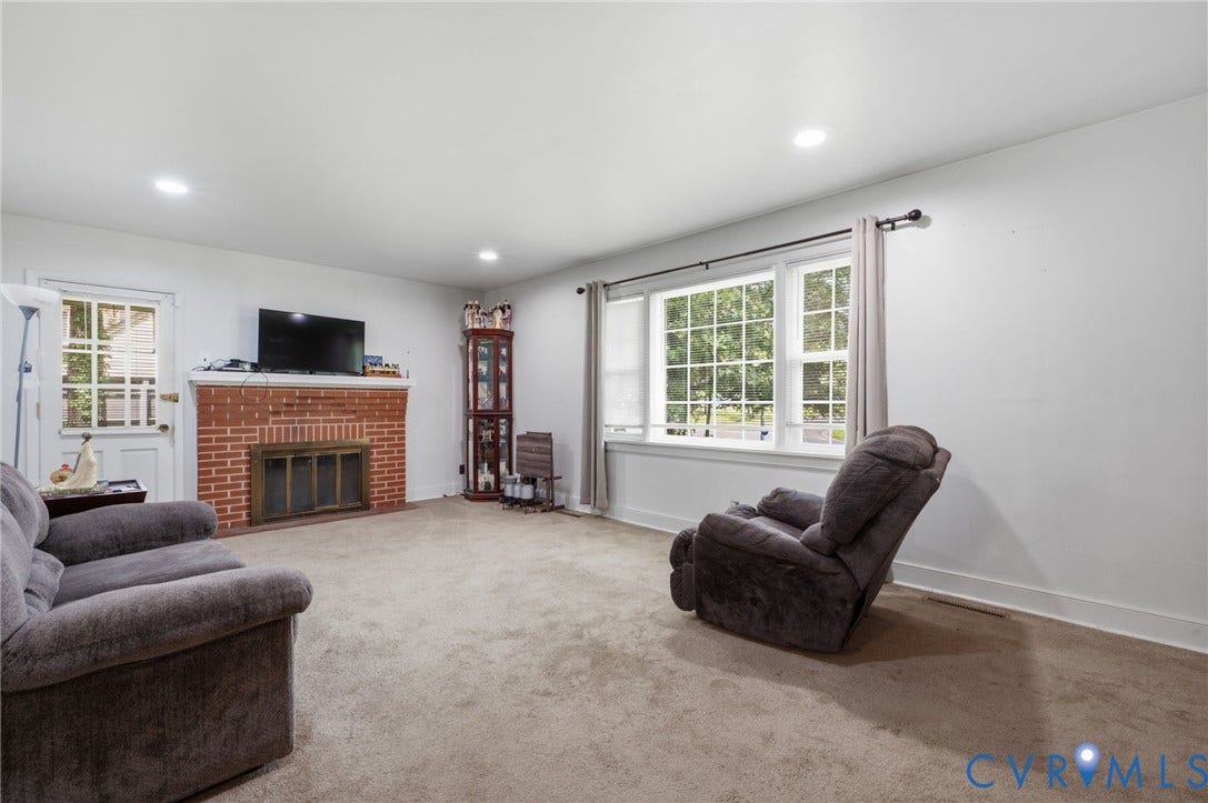 4021 Beulah Road, Chesterfield, VA 23237 Living area featuring a brick fireplace, white trim, recessed lighting, and a multi-pane window