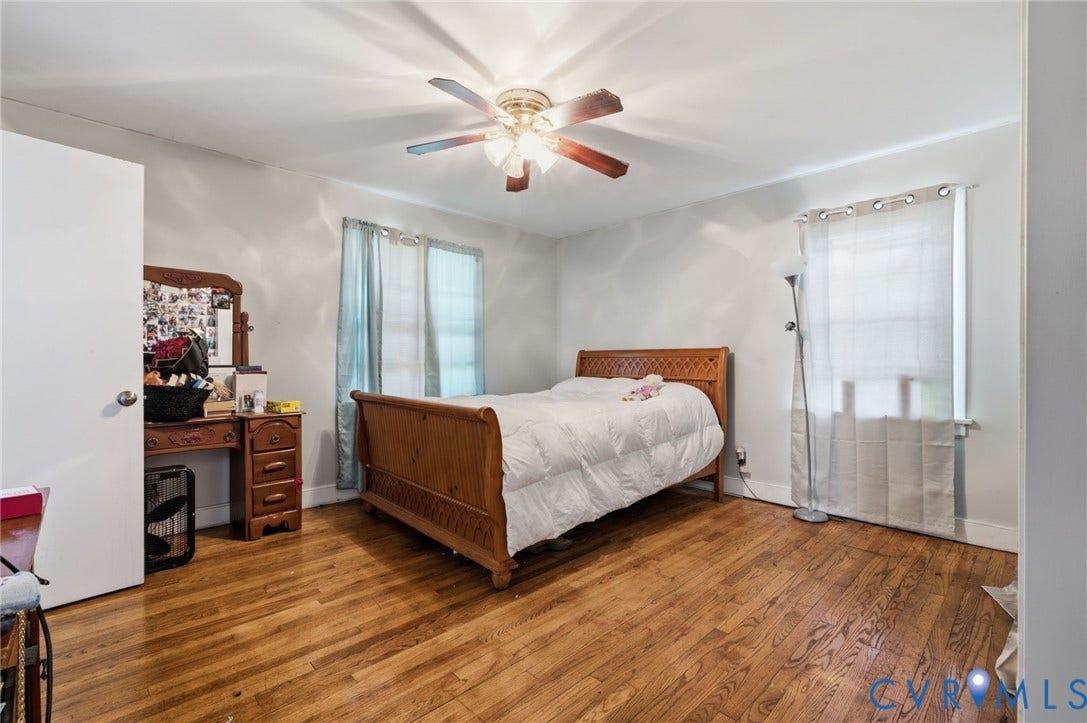 4021 Beulah Road, Chesterfield, VA 23237 Bedroom featuring wood-finish flooring, two windows, and a ceiling fan with integrated lighting