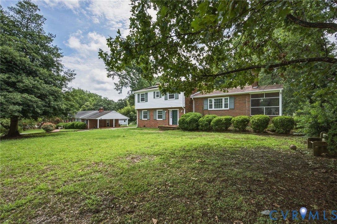 4021 Beulah Road, Chesterfield, VA 23237 Brick and white siding exterior with green shutters, featuring a screened porch and a covered carport