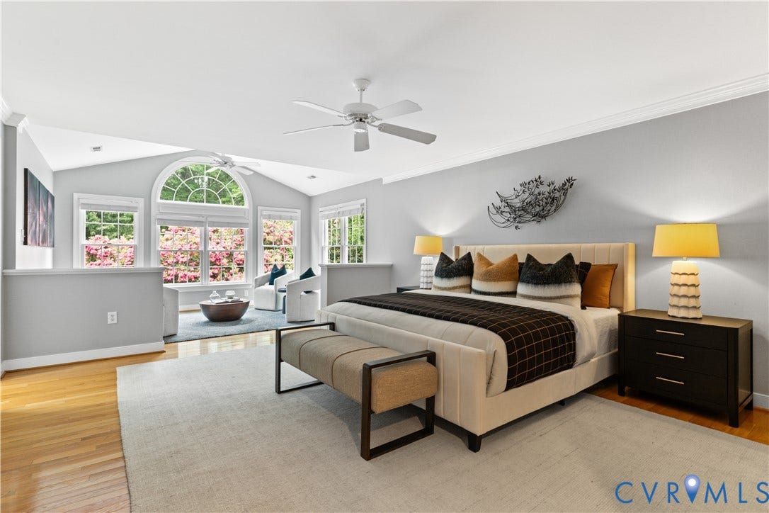Spacious interior featuring a vaulted living room attached, wood-finish flooring, and crown molding