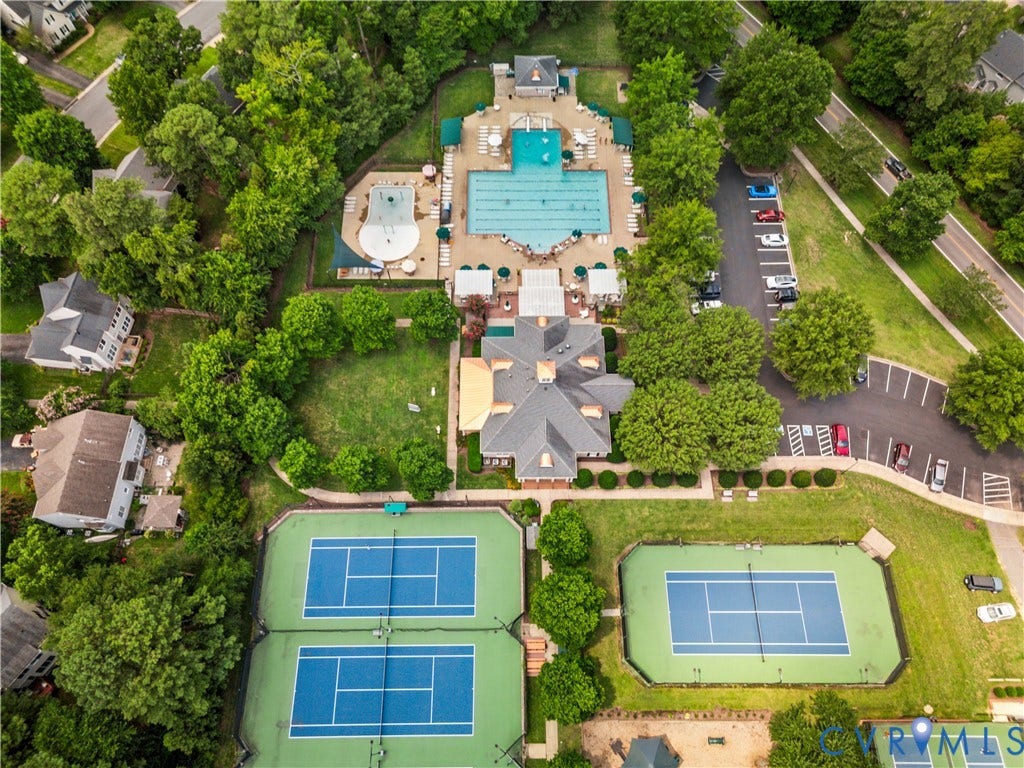 Community recreational complex featuring multiple tennis courts, a large swimming pool, and a dedicated children's pool