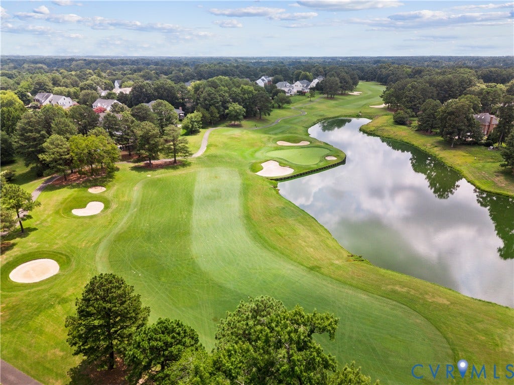Expansive golf course setting featuring manicured greens and sand traps