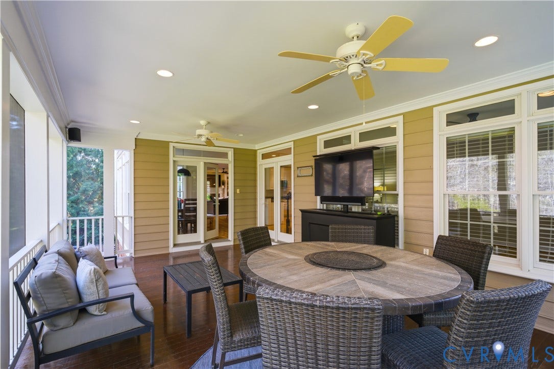 Expansive screened porch featuring recessed lighting, a ceiling fan, and rich wood-finish flooring