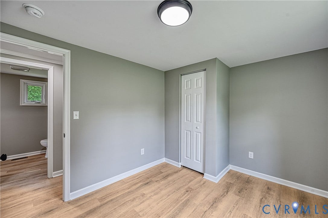 309 Ellis Drive, Louisa, VA 23093 Room featuring light wood-finish flooring, neutral gray wall paint, and white baseboards