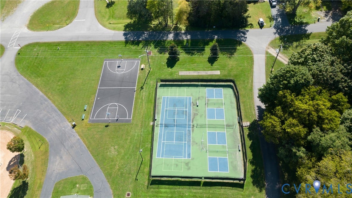 309 Ellis Drive, Louisa, VA 23093 Outdoor recreational area featuring a full basketball court, fenced tennis courts, and distinct pickleball courts
