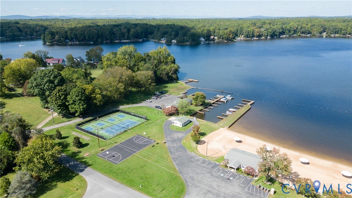 309 Ellis Drive, Louisa, VA 23093 Lakefront property with extensive amenities including a marina with multiple boat slips, a sandy beach, two tennis courts, and a basketball court