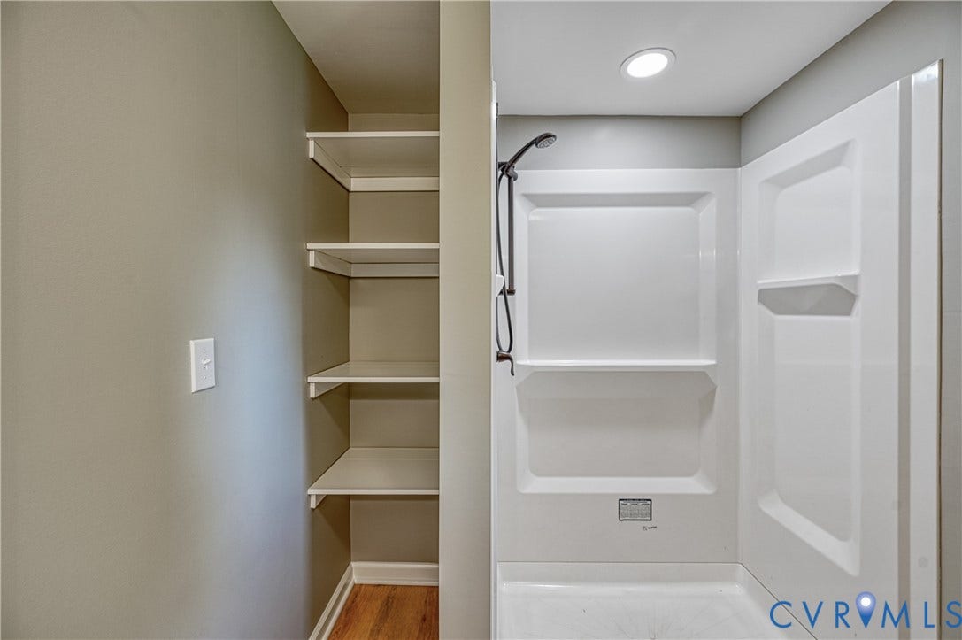309 Ellis Drive, Louisa, VA 23093 Functional bathroom featuring a white walk-in shower with a black showerhead and a recessed ceiling light