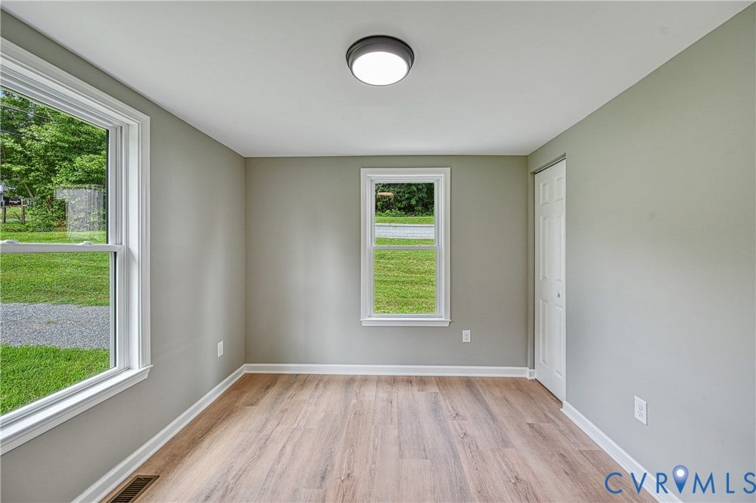 309 Ellis Drive, Louisa, VA 23093 Interior space featuring wood-finish flooring, two windows with white trim, and light gray wall paint