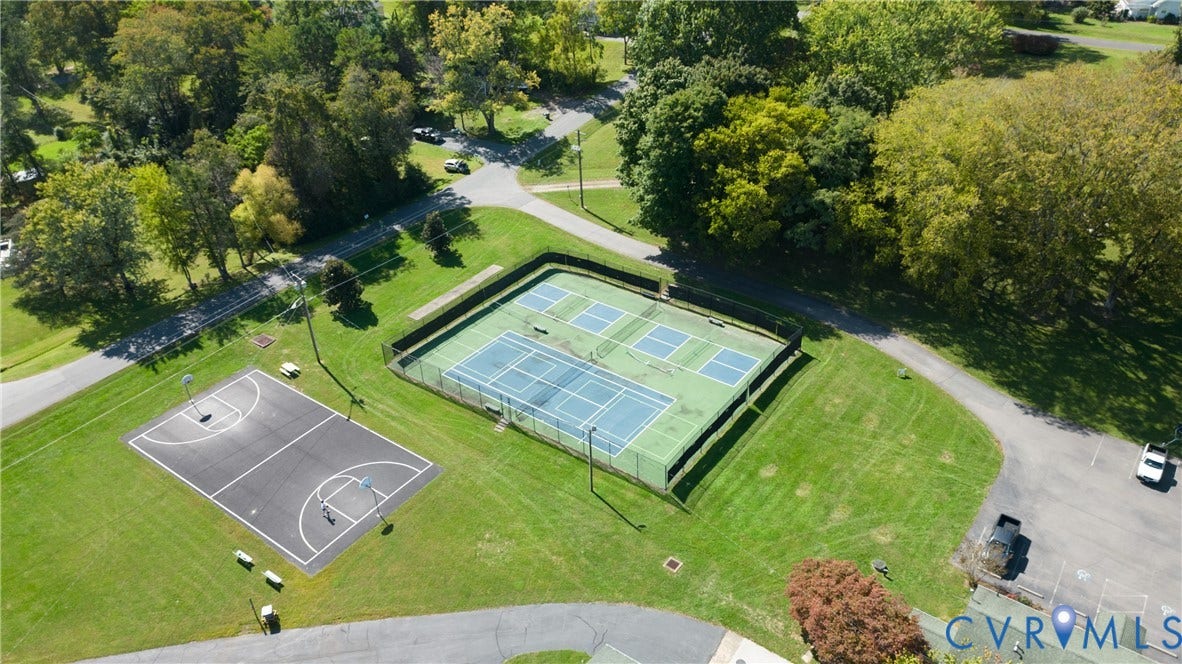 309 Ellis Drive, Louisa, VA 23093 Recreational area featuring fenced tennis courts, basketball court, and expansive green spaces