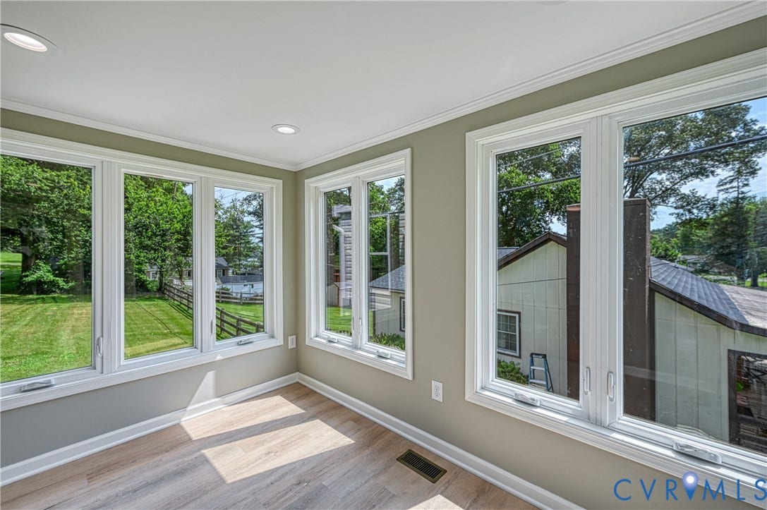 309 Ellis Drive, Louisa, VA 23093 Room featuring multiple windows with white frames, wood-finish flooring, recessed lighting, crown molding, and baseboards