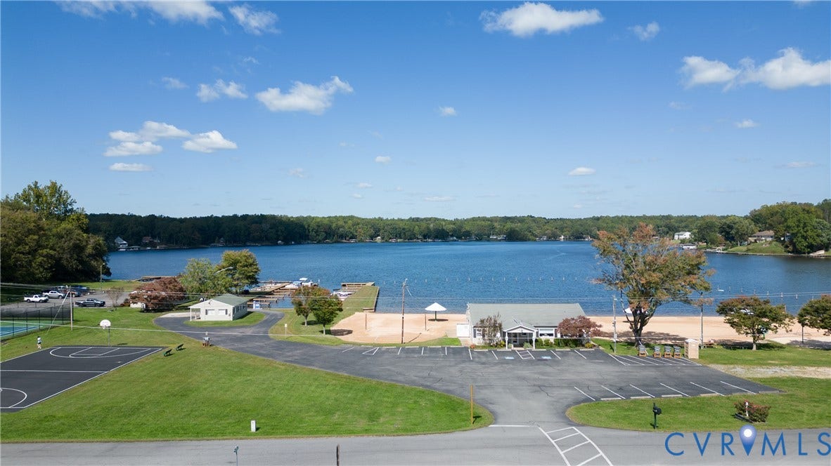 309 Ellis Drive, Louisa, VA 23093 Expansive waterfront community featuring a large lake, sandy beach, and multiple docks